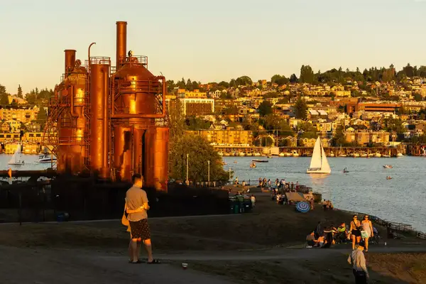People in gas works park at sunset