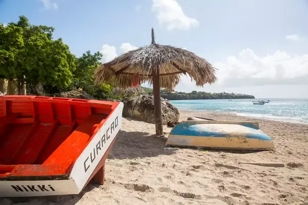 Beach umbrella and boats, Westpunt, Curacao, Caribbean 