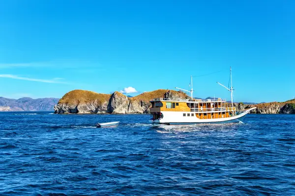 A boat near islands in the ocean amid a bright environment