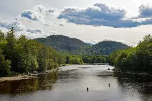 Androscoggin River near Gilead, Maine USA with fisherman and family watching