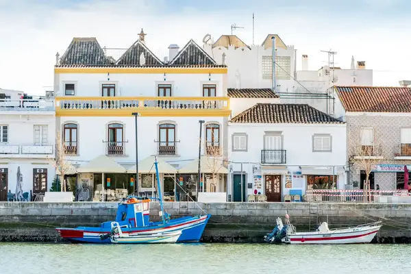 Riverside scene with boats and buildings in Tavira Portugal