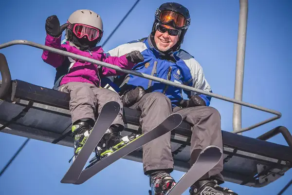 Two skiers on chairlift at Cascade Mountain, Portage, Wisconsin