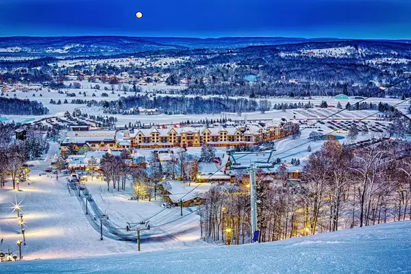 The moon rises over a ski hill at Boyne Mountain Resort in Michigan.