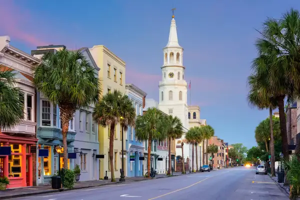 A picturesque street with pastel-painted buildings and a historic church in Charleston, South Carolina