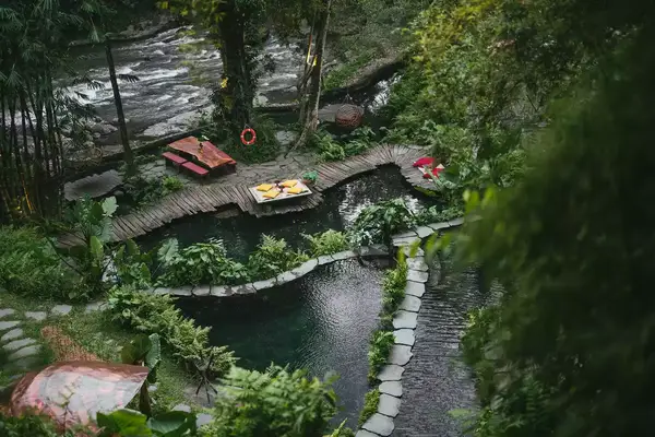 Aerial view of riverside pools at Bambu Indah in Bali