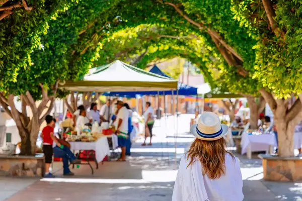 A woman walking through a plaza