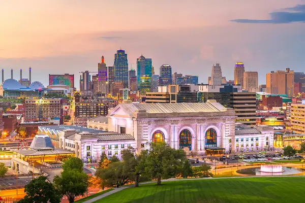 Kansas City, Missouri, USA downtown skyline with Union Station at dusk.