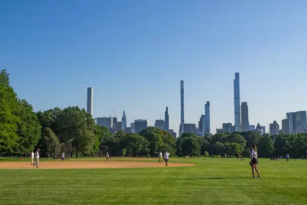 A baseball field surrounded by skyscrapers 