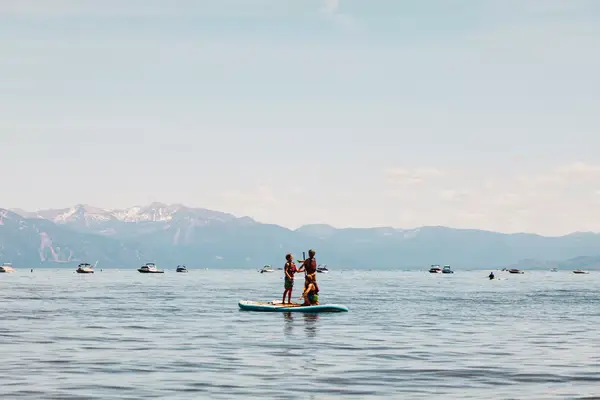 Kids paddle-boarding in a lake