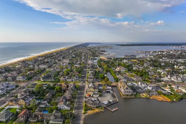 Aerial view of a coastal town featuring residential streets, waterways, and a beach