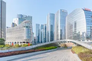 A view of modern city buildings connected by an elevated pedestrian walkway