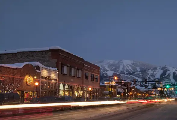 Downtown Steamboat Springs at dusk with snowy mountain in background