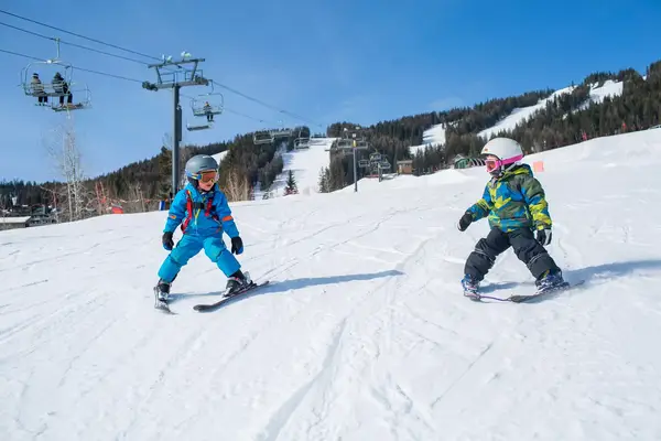 Two small children learning to ski