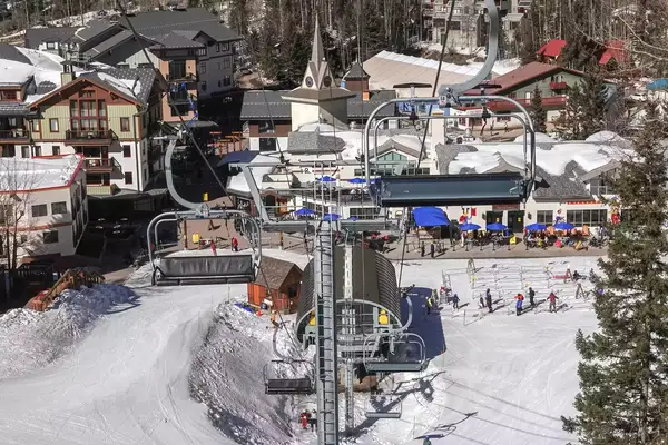 Skiers and snowboarders at the base of Taos, New Mexico ski resort