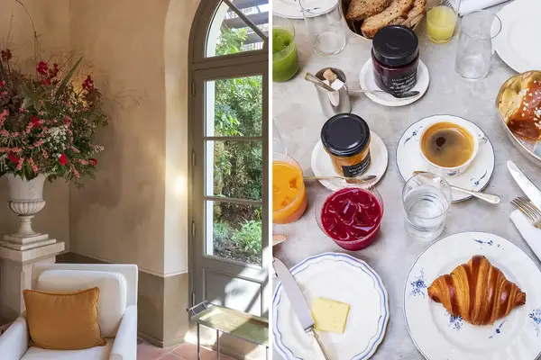 A cozy seating area with a chair and floral arrangement next to a window paired with a breakfast table setup featuring pastries and beverages