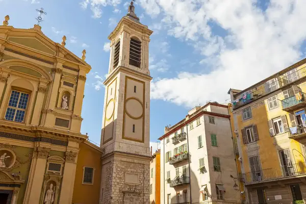 A historical church tower in an old town square in Nice France