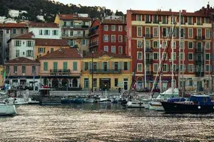 The port in Nice with colorful buildings in the background.