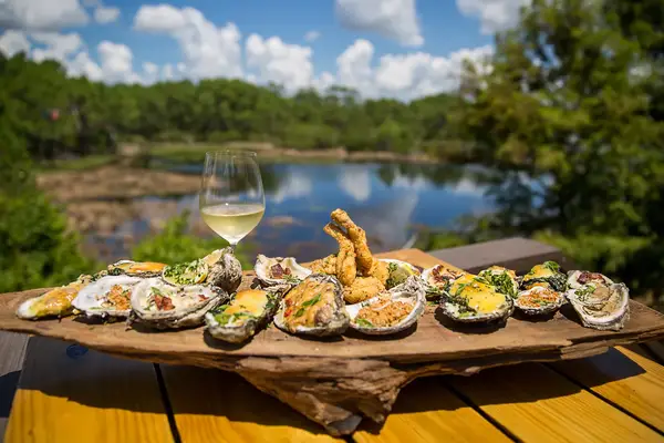 A glass of wine and tray of oysters from Stinkys Fish Camp in 30A, Florida 