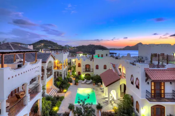 High vantage point of the buildings and pool at sunset at Cap Maison 