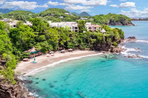 Beach with sailboat at Cap Maison
