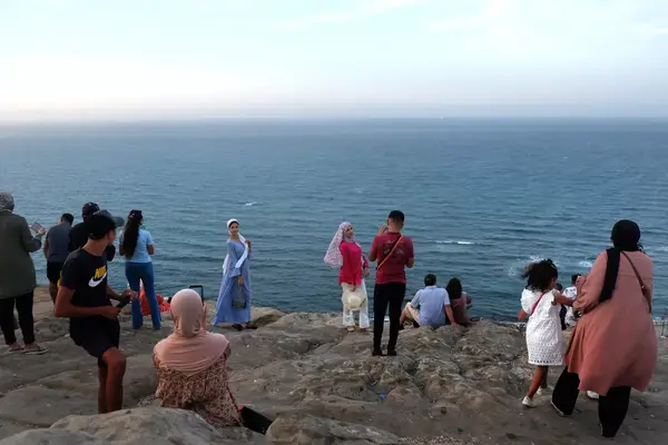 People taking photos on the sea in Tangier