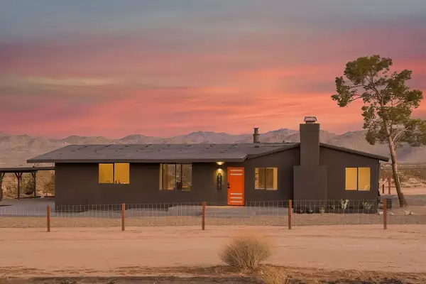 Black Rock Homestead in Joshua Tree, a modern black home with minimal warm interiors