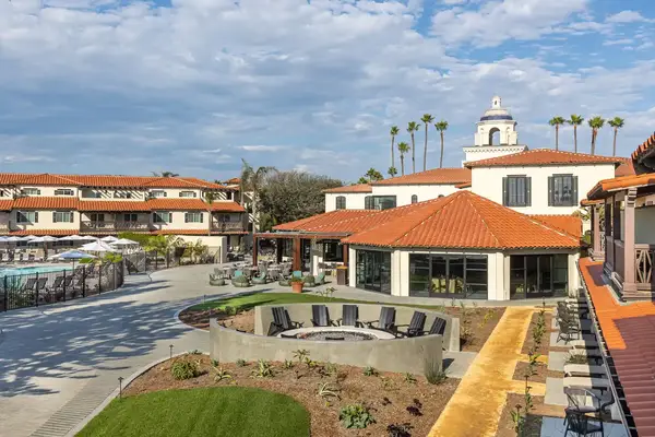 A luxury resort courtyard with a seating area pool and Mediterraneanstyle architecture