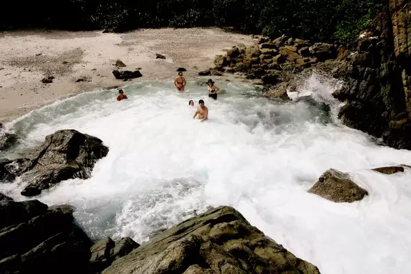 A group enjoying a natural pool