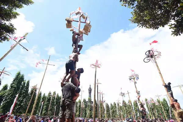 Indonesians celebrate their 72nd independence day by doing greased pole climbing competition to win some prizes include motorcycle, in Renon Park, Bali, Indonesia