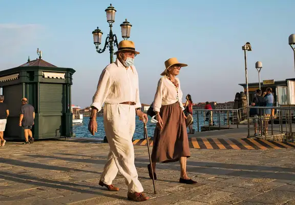 A stylish Italian couple walking at Zattere