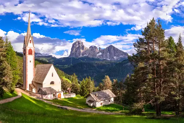 Amazing Alpine scenery. Beautiful Dolomites mountains. view of San Giacomo church near Ortisei village. Val Gardena, South Tyrol, Italy