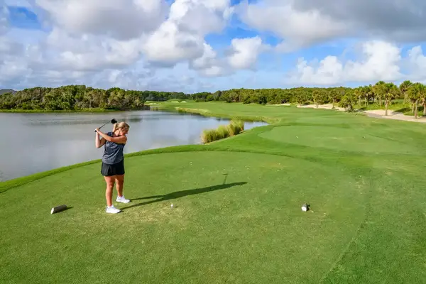 A woman golfing at Bald Head Island Club Golf Course
