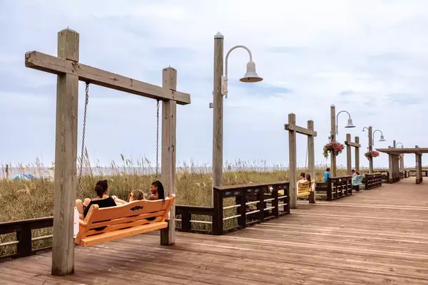 Swing benches on a boardwalk in Carolina Beach