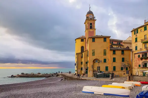 Camogli is a fishing village not too far from Genoa, Liguria, Italy. ItÃ¢ÂÂs a stunning town with impressive multi-coloured houses, a picturesque harbour and a little fortress at the top of a steep cliff.