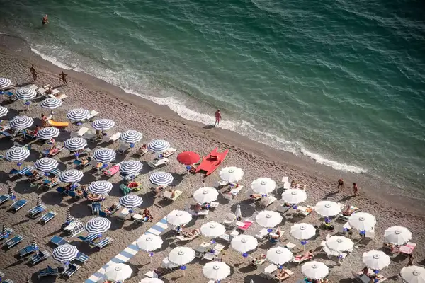  Umbrellas and sunbeds at the free beach of the bay between Salerno and Vietri sul Mare