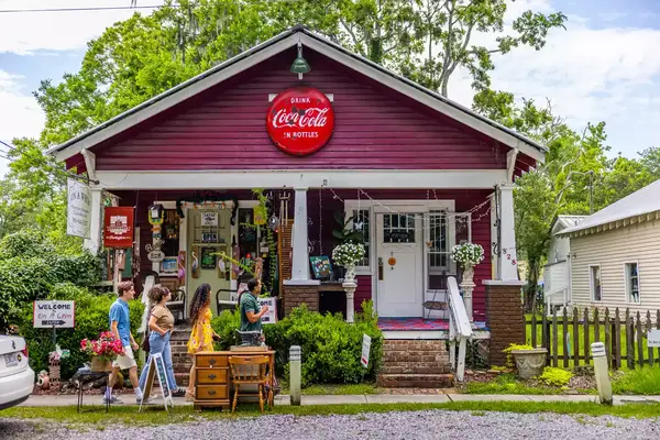 A group of people passing a store.