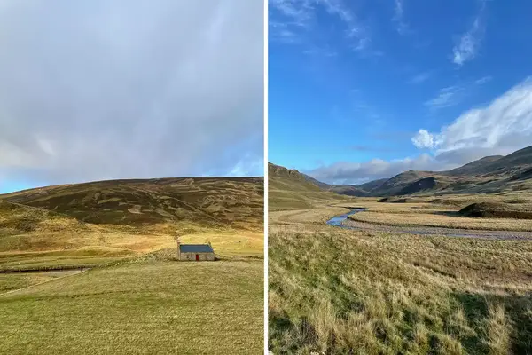 A small structure on rolling hills, a river weaving through a valley