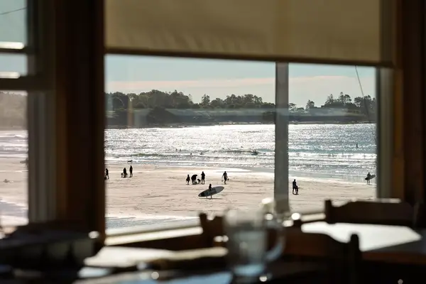 Sunny beach scene shot through a window.