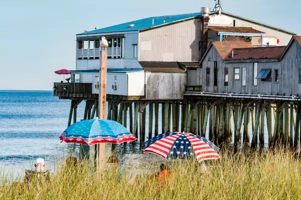 People enjoy the beach near to the Historic Old Orchard Beach Pier, which since 1898 has been one of the main attractions in Maine. Old Orchard Beach