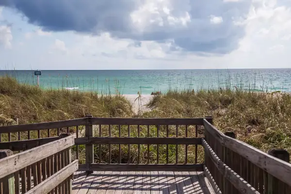View of a beach over a wood railing