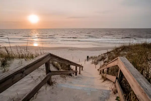 A sandy staircase leading to a beach