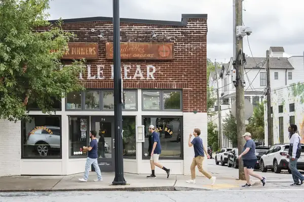 Street view of Little Bear restaurant people walking on the sidewalk outside