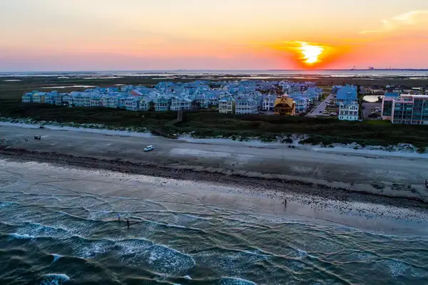 Sun rises above Crashing waves on Padre Island National Shoreline Beach near Port Aransas Texas