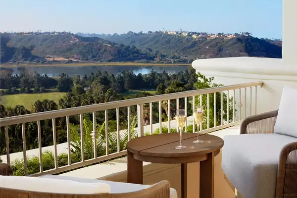 A suite overlooking mountains and water at Park Hyatt Aviara