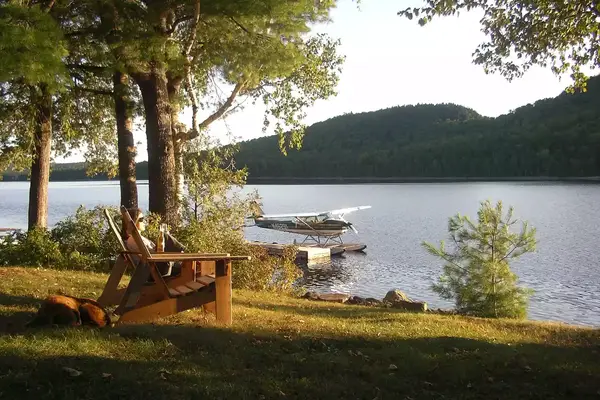Adirondack chairs on the lake at Bradford Camps in Maine