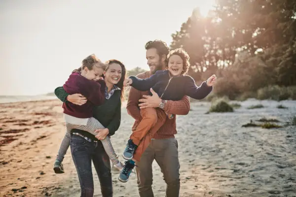 close up of a happy family enjoying time on the beach