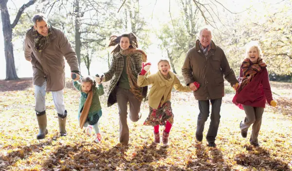 extended family running in park in autumn