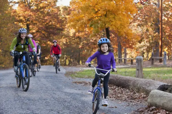 family riding bicycles in park