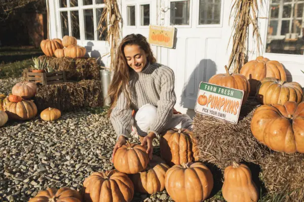 woman on a harvest festival at pumpkin farm