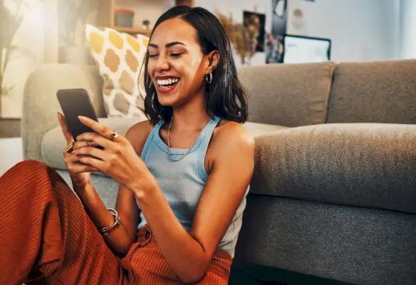 teen girl friends hanging out together, sitting on floor, laughing